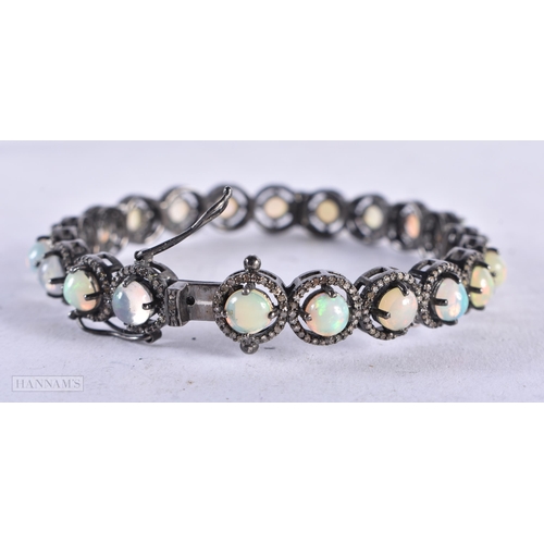 3916 - An Opal and Diamond Bangle. Internal diameter 5.9cn, weight 23.7g