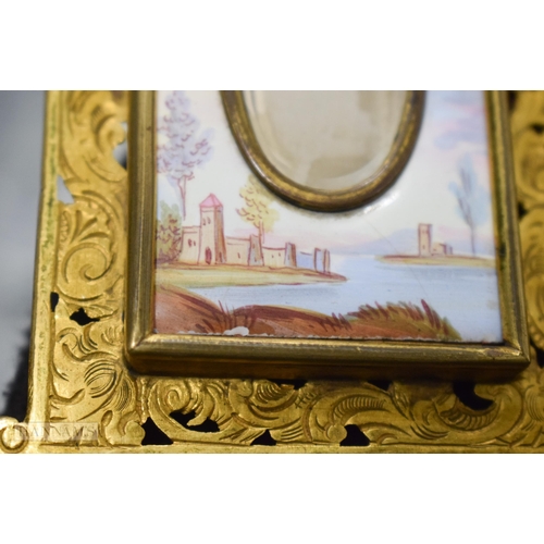 772 - A LATE 19TH CENTURY AUSTRIAN SWISS ENAMEL FRAME painted with figures in landscapes. 20 cm x 13 cm.