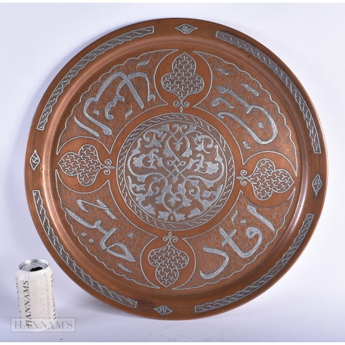 11 - A VERY LARGE 19TH CENTURY MIDDLE EASTERN SILVER INLAID CHARGER decorated with scripture. 54 cm diame... 