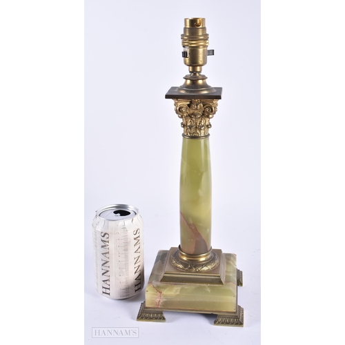 13 - AN EARLY 20TH CENTURY FRENCH BRONZE AND ONYX ACANTHUS CAPPED LAMP. 35 cm high.