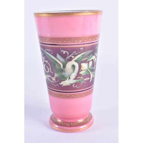 131 - A 19TH CENTURY ENAMELLED PINK OPALINE GLASS BEAKER painted in relief with mythical birds. 15cm high.