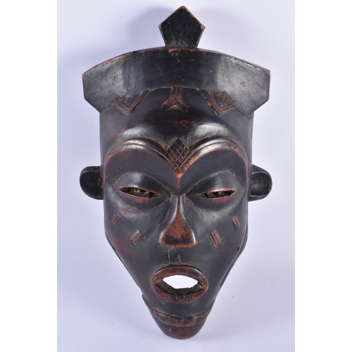 134 - AN AFRICAN TRIBAL CARVED WOOD MASK. 34 cm x 18cm.