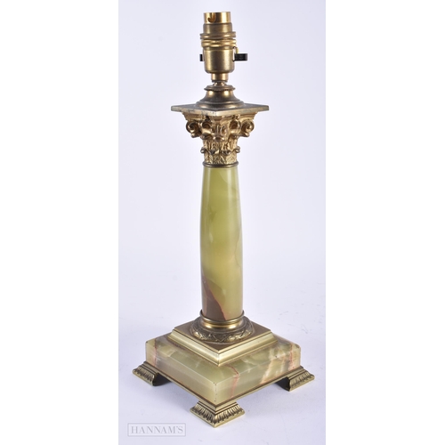 13 - AN EARLY 20TH CENTURY FRENCH BRONZE AND ONYX ACANTHUS CAPPED LAMP. 35 cm high.