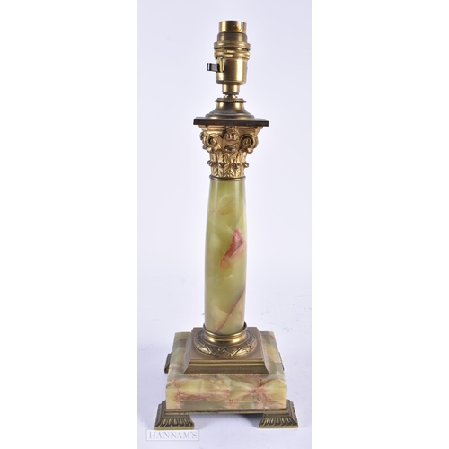 13 - AN EARLY 20TH CENTURY FRENCH BRONZE AND ONYX ACANTHUS CAPPED LAMP. 35 cm high.