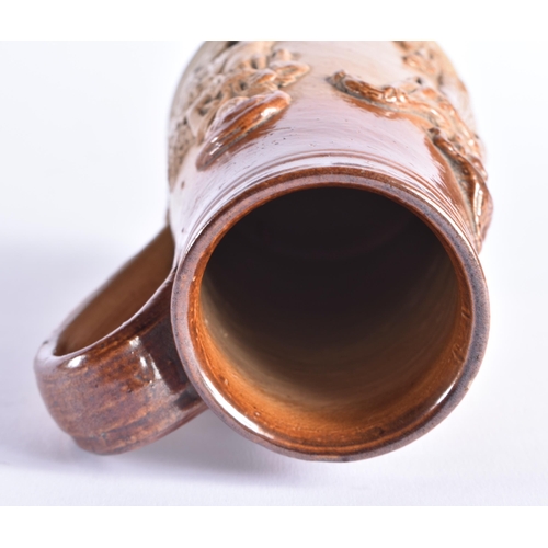 150 - A RARE MID 19TH CENTURY STONEWARE SHAVING MUG decorated with figural sprigs. 14cm high.