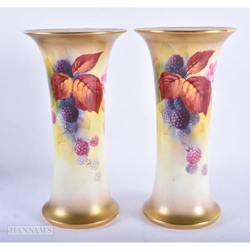 152 - A PAIR OF ROYAL WORCESTER PORCELAIN VASES by Kitty Blake. 19 cm high.