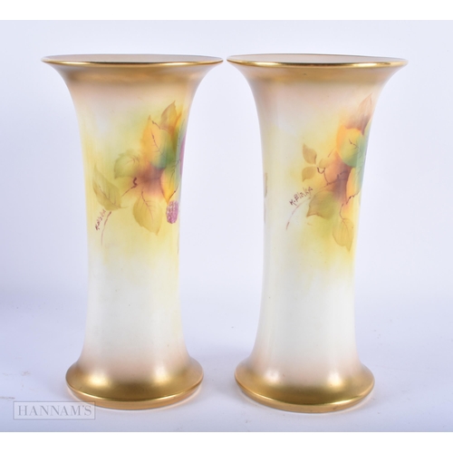 152 - A PAIR OF ROYAL WORCESTER PORCELAIN VASES by Kitty Blake. 19 cm high.