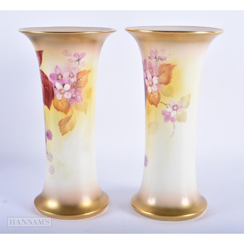 152 - A PAIR OF ROYAL WORCESTER PORCELAIN VASES by Kitty Blake. 19 cm high.