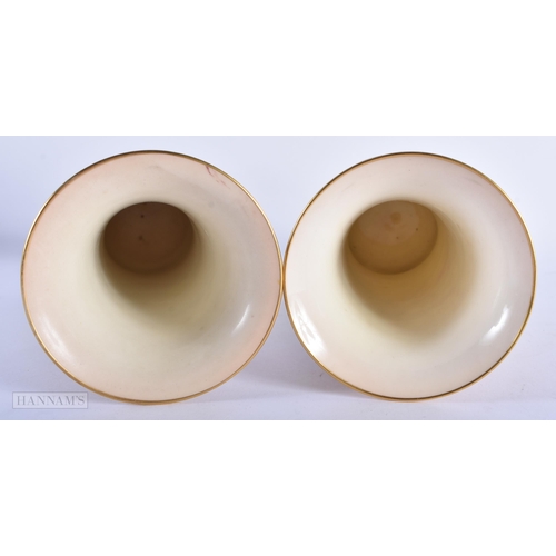 152 - A PAIR OF ROYAL WORCESTER PORCELAIN VASES by Kitty Blake. 19 cm high.