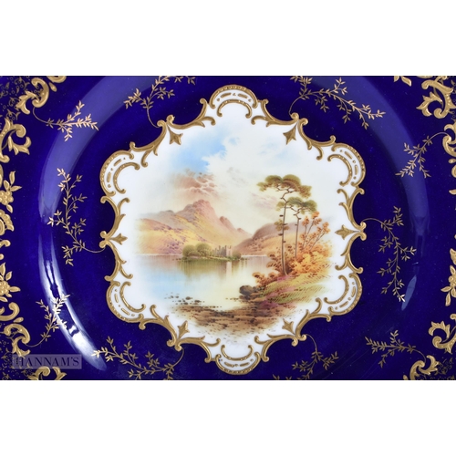 169 - A FINE PAIR OF COALPORT CABINET PLATES by Simpson, painted with landscapes. 24 cm wide.