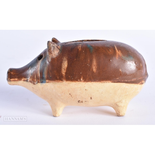 17 - A CHARMING ANTIQUE TREACLE GLAZED SLIP DECORATED POTTERY PIG MONEY BOX. 12 cm wide.