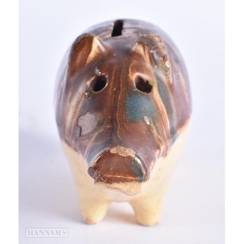 17 - A CHARMING ANTIQUE TREACLE GLAZED SLIP DECORATED POTTERY PIG MONEY BOX. 12 cm wide.