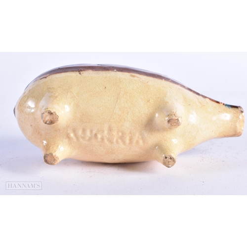 17 - A CHARMING ANTIQUE TREACLE GLAZED SLIP DECORATED POTTERY PIG MONEY BOX. 12 cm wide.