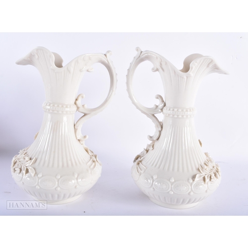 170 - A LARGE PAIR OF IRISH BELEEK PORCELAIN JUGS. 23.5 cm high.