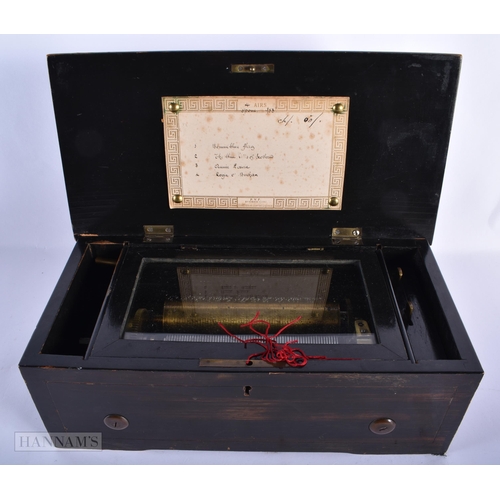 214 - A 19TH CENTURY SWISS MUSICAL BOX playing four airs. 31 cm x 15cm, barrel 14.5 cm wide.