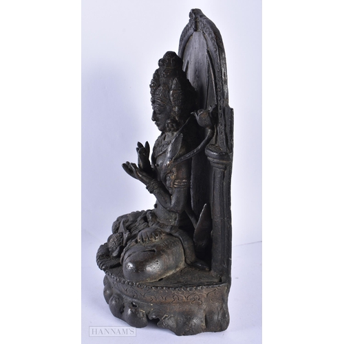 225 - A 17TH/18TH CENTURY INDIAN NEPALESE BRONZE BUDDHA SHRINE formed with a figure upon a lotus. 25 cm x ... 