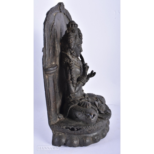 225 - A 17TH/18TH CENTURY INDIAN NEPALESE BRONZE BUDDHA SHRINE formed with a figure upon a lotus. 25 cm x ... 