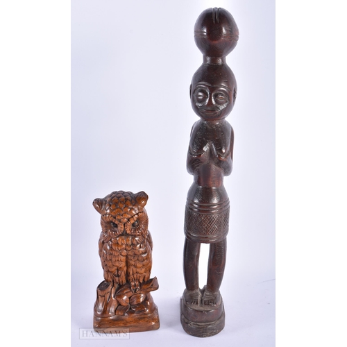 226 - AN ANTIQUE BAVARIAN BLACK FOREST CARVED WOOD OWL together with an African tribal figure. Largest 36 ... 