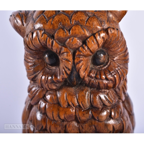 226 - AN ANTIQUE BAVARIAN BLACK FOREST CARVED WOOD OWL together with an African tribal figure. Largest 36 ... 