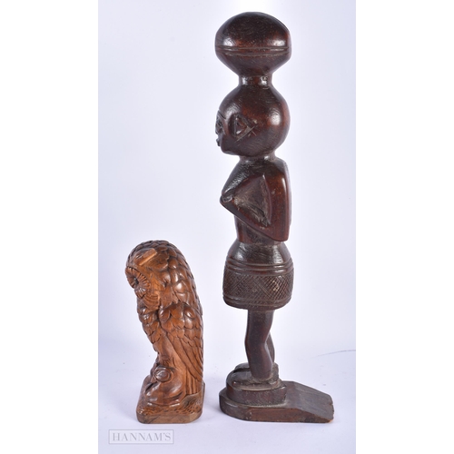 226 - AN ANTIQUE BAVARIAN BLACK FOREST CARVED WOOD OWL together with an African tribal figure. Largest 36 ... 