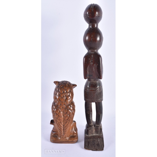 226 - AN ANTIQUE BAVARIAN BLACK FOREST CARVED WOOD OWL together with an African tribal figure. Largest 36 ... 