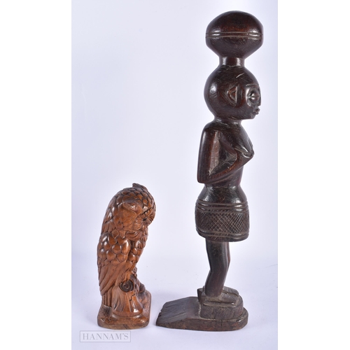 226 - AN ANTIQUE BAVARIAN BLACK FOREST CARVED WOOD OWL together with an African tribal figure. Largest 36 ... 