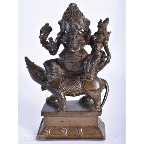 239 - A 19TH CENTURY INDIAN BRONZE FIGURE OF GANESHA modelled with attendants. 15cm high.