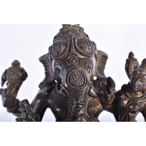 239 - A 19TH CENTURY INDIAN BRONZE FIGURE OF GANESHA modelled with attendants. 15cm high.