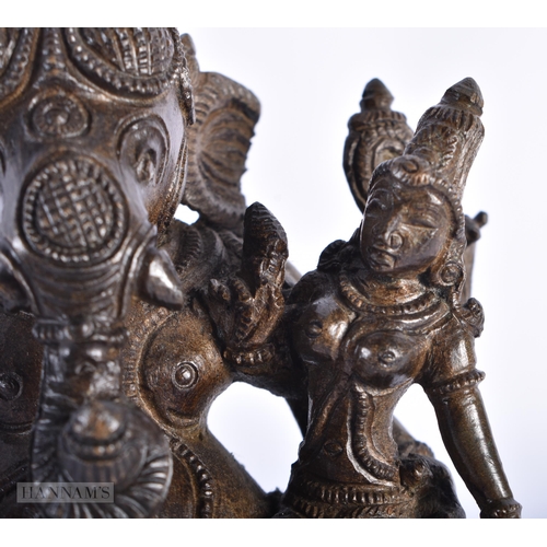 239 - A 19TH CENTURY INDIAN BRONZE FIGURE OF GANESHA modelled with attendants. 15cm high.