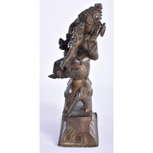 239 - A 19TH CENTURY INDIAN BRONZE FIGURE OF GANESHA modelled with attendants. 15cm high.