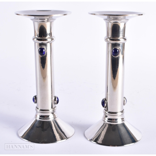 24 - A PAIR OF ART DECO BLUE GLASS CABOCHON SILVER PLATED CANDLESTICKS. 17 cm high.