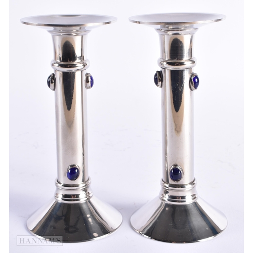 24 - A PAIR OF ART DECO BLUE GLASS CABOCHON SILVER PLATED CANDLESTICKS. 17 cm high.