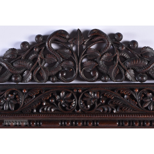 260 - A LARGE 19TH CENTURY ANGLO INDIAN COUNTRY HOUSE CARVED WOOD MIRROR formed with foliage and serpents.... 