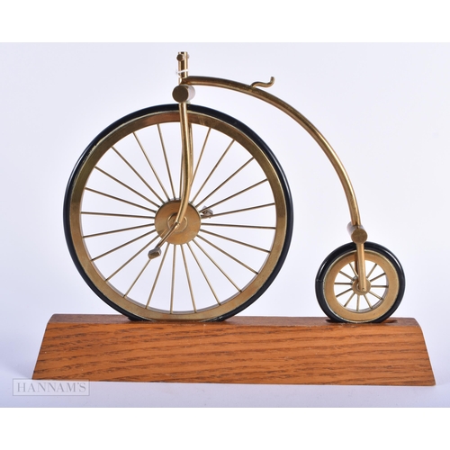 272 - A BRASS AND LEATHER MODEL OF A PENNY FARTHING BICYCLE. 25 cm x 22cm.