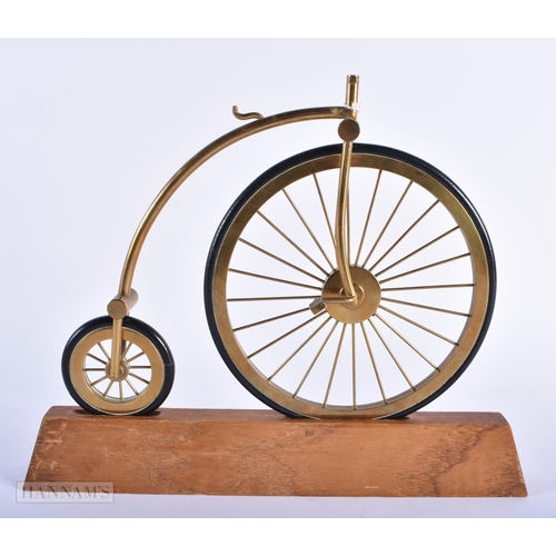 272 - A BRASS AND LEATHER MODEL OF A PENNY FARTHING BICYCLE. 25 cm x 22cm.