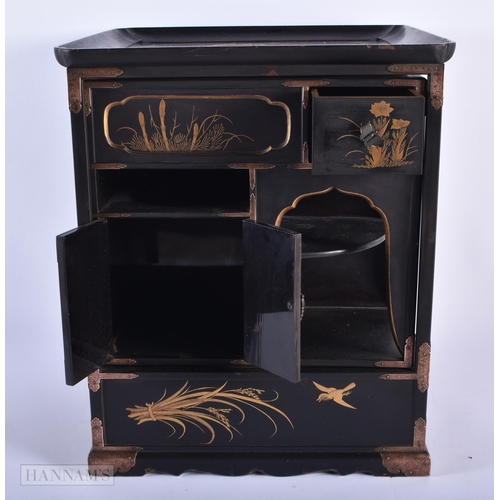 281 - A LATE 19TH CENTURY JAPANESE MEIJI PERIOD BLACK LACQUER CABINET decorated in gilt with birds and fol... 