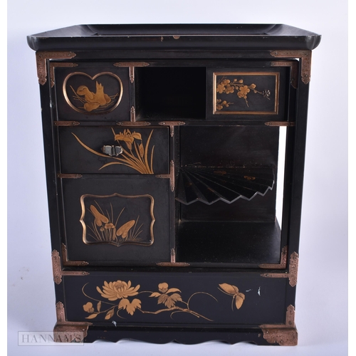 281 - A LATE 19TH CENTURY JAPANESE MEIJI PERIOD BLACK LACQUER CABINET decorated in gilt with birds and fol... 