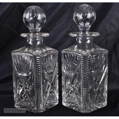 294 - A PAIR OF CUT GLASS WHISKEY DECANTERS AND STOPPERS. 27cm high.