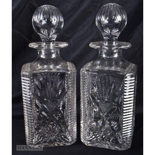 294 - A PAIR OF CUT GLASS WHISKEY DECANTERS AND STOPPERS. 27cm high.