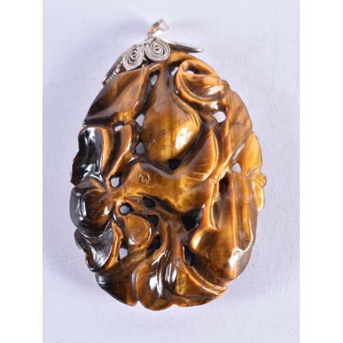 302 - A 19TH CENTURY CHINESE CARVED TIGERS EYE SILVER MOUNTED PENDANT. 23.3 grams. 5.5 cm x 4 cm.