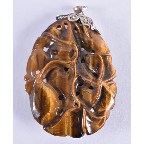 302 - A 19TH CENTURY CHINESE CARVED TIGERS EYE SILVER MOUNTED PENDANT. 23.3 grams. 5.5 cm x 4 cm.