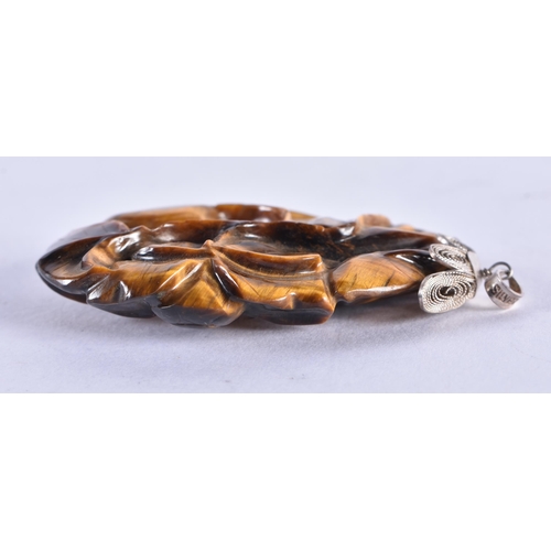 302 - A 19TH CENTURY CHINESE CARVED TIGERS EYE SILVER MOUNTED PENDANT. 23.3 grams. 5.5 cm x 4 cm.