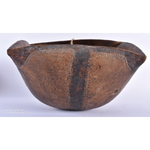 310 - AN AFRICAN TRIBAL CARVED WOOD FOOD BOWL. 32 cm x 20 cm.