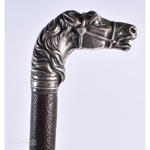 314 - A LATE VICTORIAN/EDWARDIAN WHITE METAL EQUESTRIAN HORN HEAD RIDING CROP. 60cm long.