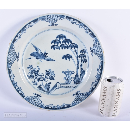 317 - A LARGE 18TH CENTURY DELFT BLUE AND WHITE TIN GLAZED DISH painted with birds and a fenced garden. 30... 