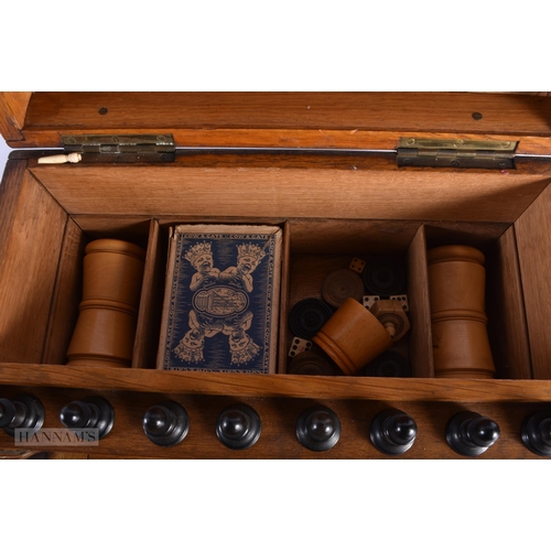 334 - A LOVELY LATE VICTORIAN CARVED OAK GAMING COMPENDIUM signed to interior Austin & Co Dublin, with mul... 