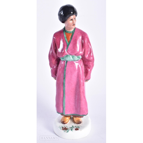 335 - A VERY RARE EARLY 20TH CENTURY RUSSIAN SOVIET PORCELAIN FIGURE OF A MALE modelled wearing a pink rob... 