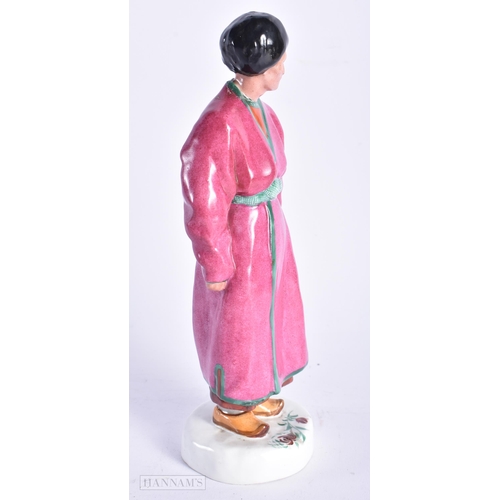 335 - A VERY RARE EARLY 20TH CENTURY RUSSIAN SOVIET PORCELAIN FIGURE OF A MALE modelled wearing a pink rob... 