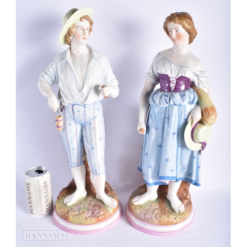 349 - A VERY LARGE PAIR OF 19TH CENTURY GERMAN PORCELAIN FIGURES modelled as a male and female beside a tr... 