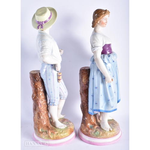 349 - A VERY LARGE PAIR OF 19TH CENTURY GERMAN PORCELAIN FIGURES modelled as a male and female beside a tr... 